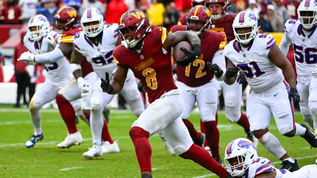Washington Commanders running back Brian Robinson Jr. (8) carries the ball against the Buffalo Bills during the second half at FedExField.